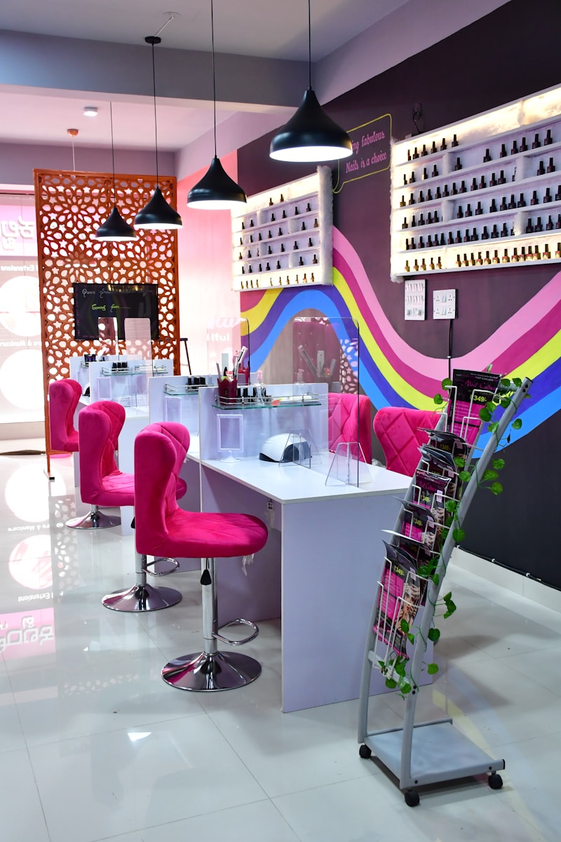 a pink chair in a room with a table and chairs